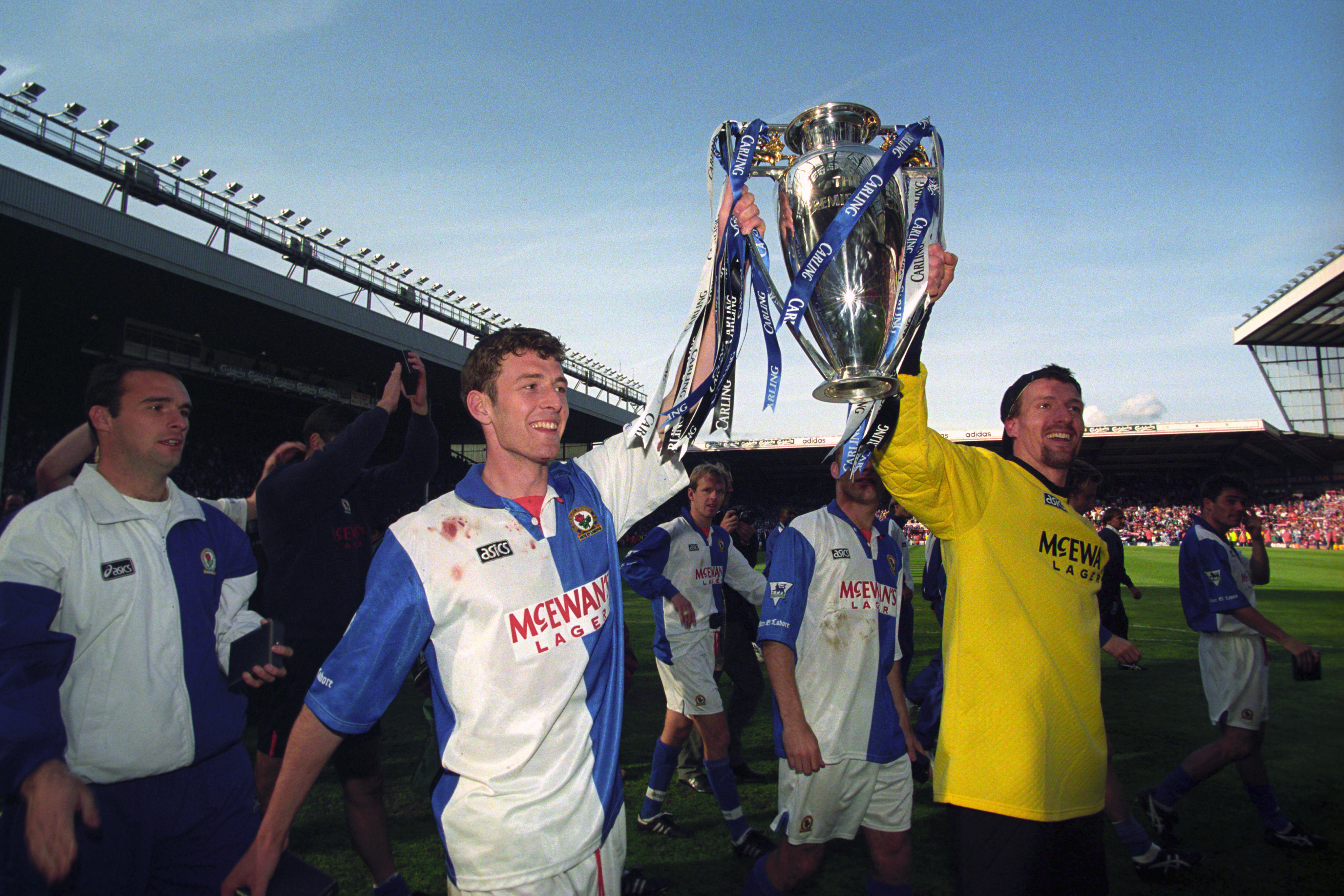 Chris Sutton holds the Premier League trophy with Blackburn Rovers teammate Tim Flowers, May 1995