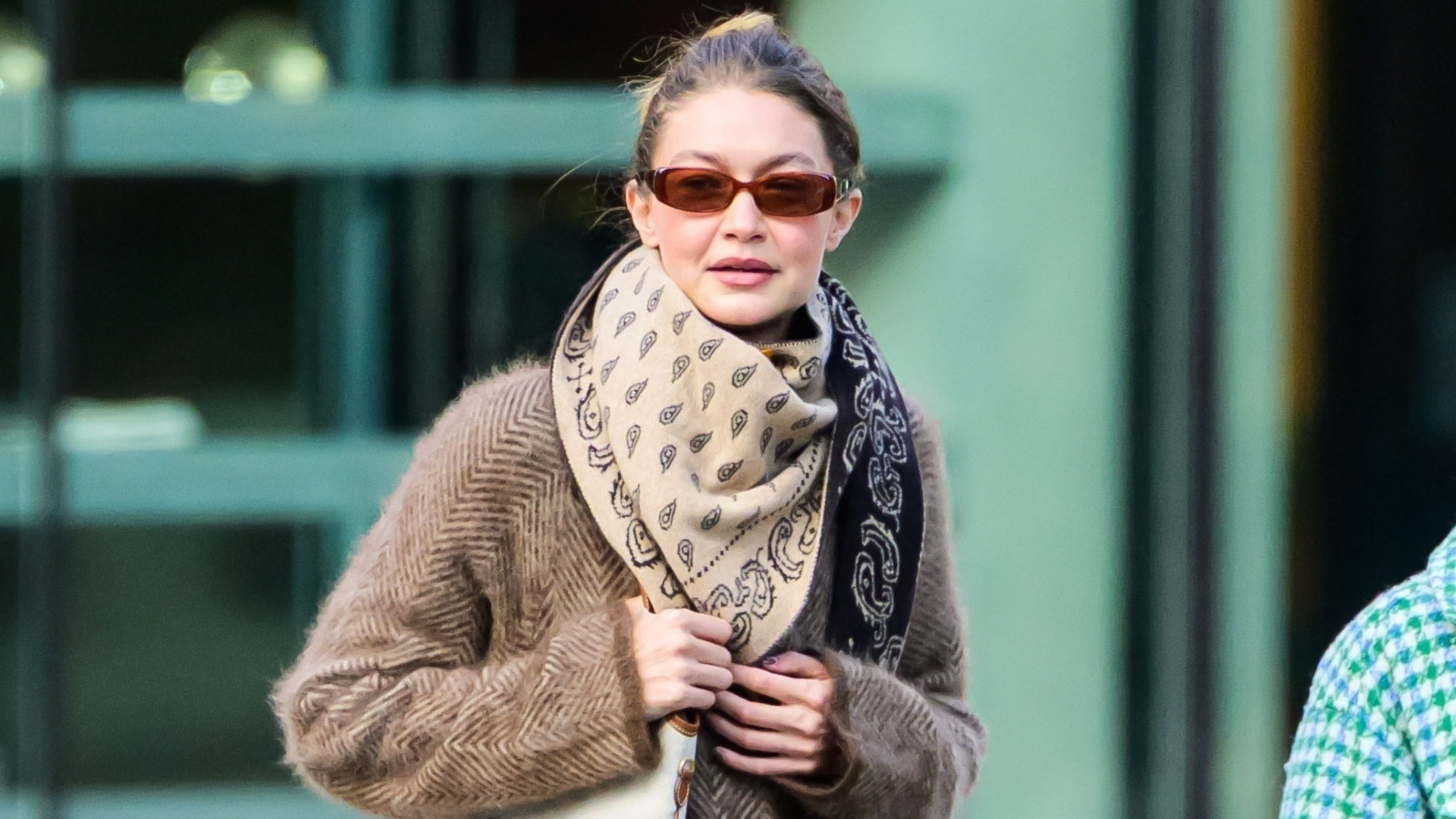 Gigi Hadid was spotted in New York wearing a wool coat, a Miu Miu bag, and fuzzy slippers