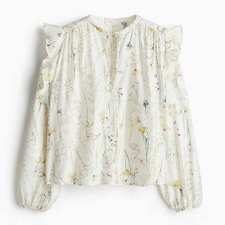 A cutout of a white floral blouse by H&M