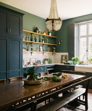 Blue and green devol kitchen with a chandelier