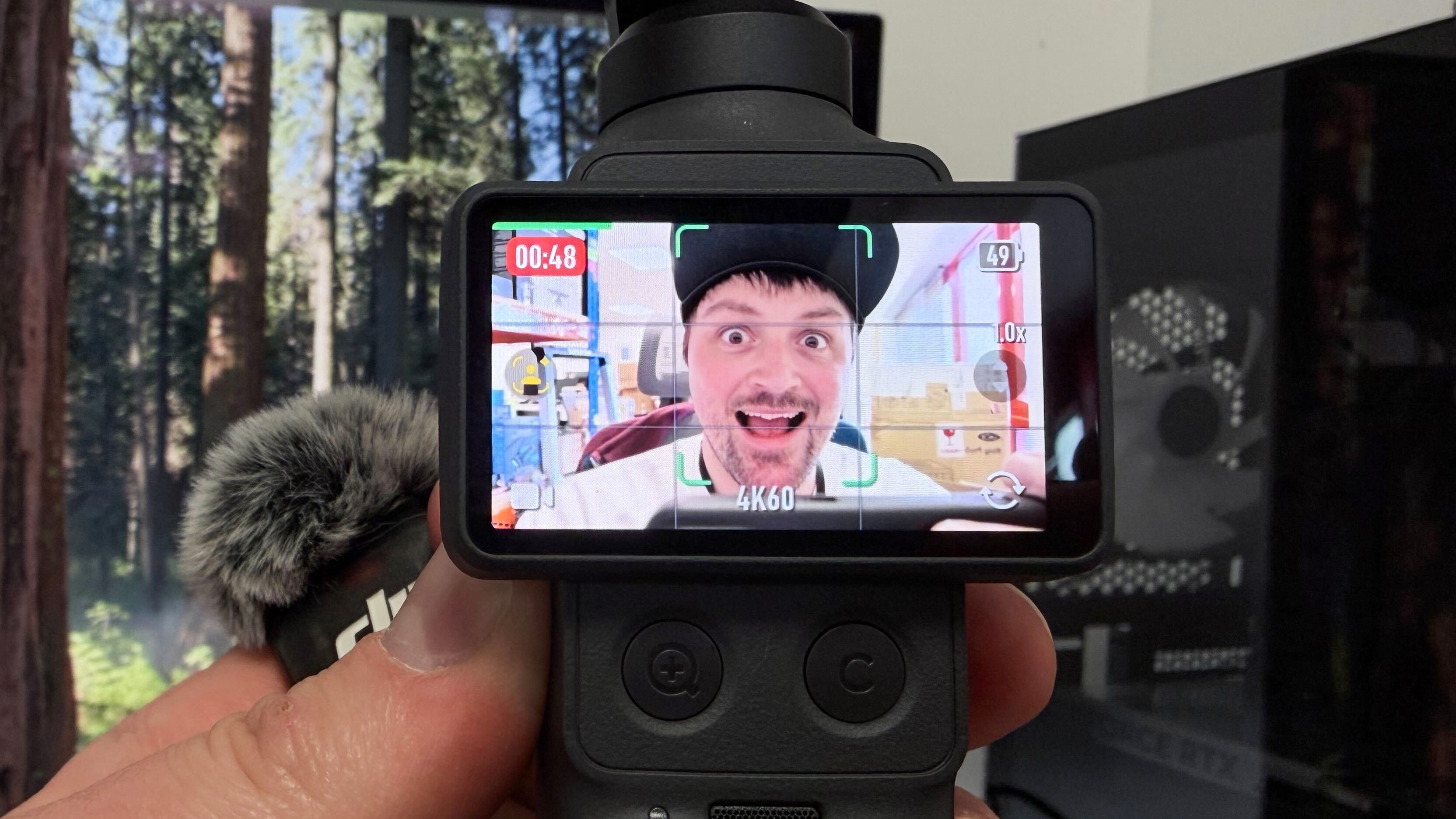 The DJI Osmo Pocket 4 with the screen being used to view tracked subjects in frame