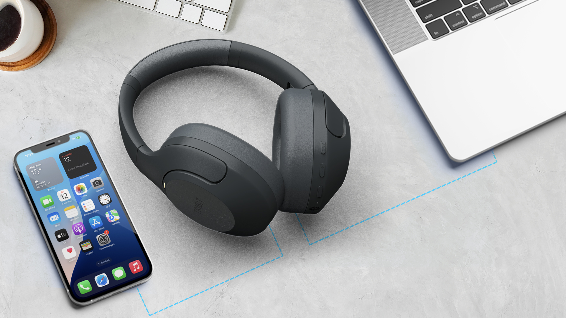 Tribit QuietPlus 81 wireless headphones in black on a desk next to a smartphone