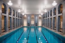 interior vista of Yrjönkatu, the indoors Helsinki swimming hall with its tall ceilings, art deco detailing and pool in the middle