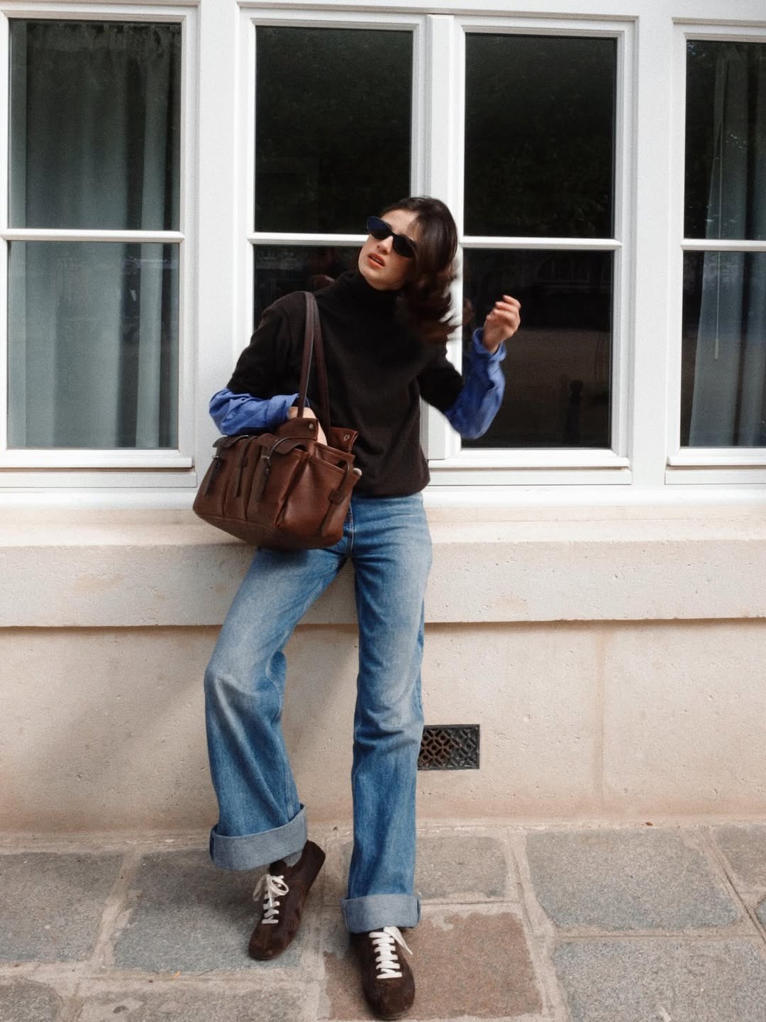 @bennipi wearing a brown top with jeans and carrying her brown leather Prada Route bag.
