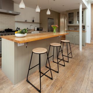 kitchen with island and wooden worktops and stools