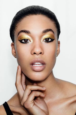 Model wearing gold eyeshadow