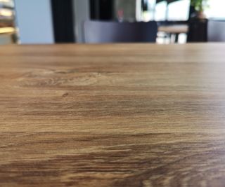 Polished wooden table in open-plan kitchen diner