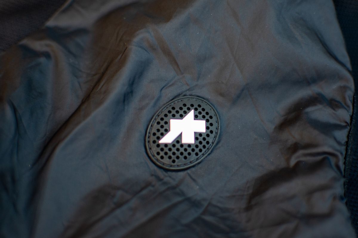 A black Assos Tactica T5 vest on some paving slabs