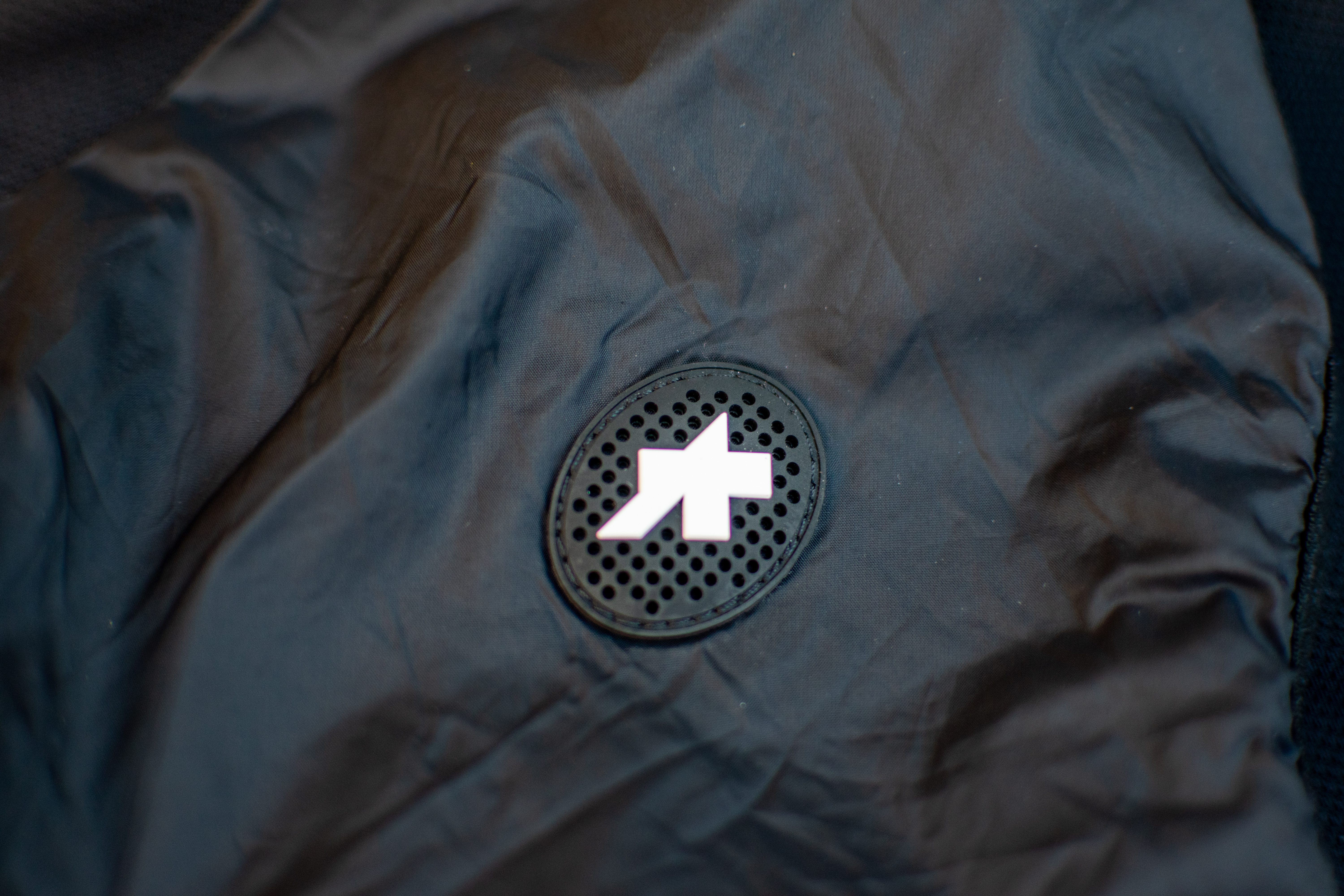 A black Assos Tactica T5 vest on some paving slabs