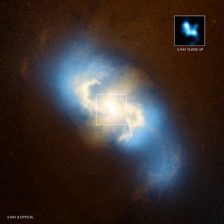 A cannibal black hole devours another in this image of a galaxy merger.