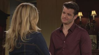 Michael Mealor as Kyle smiling at a woman in The Young and the Restless