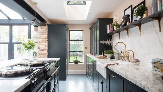 Galley kitchen with glass roof extension and green/black cabinets