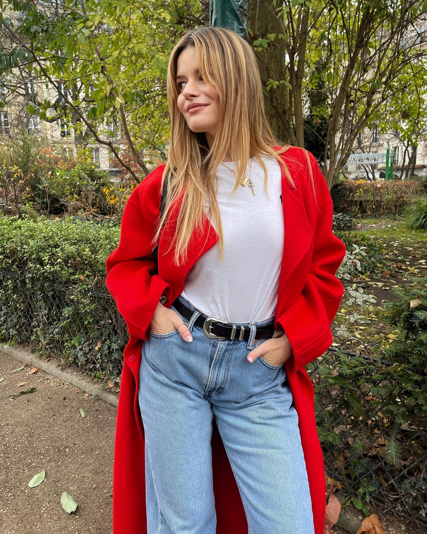 Sabina Socol wears a red coat and jeans