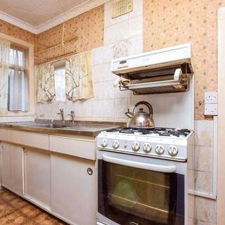 kitchen room with cabinet and wall tiles with sink