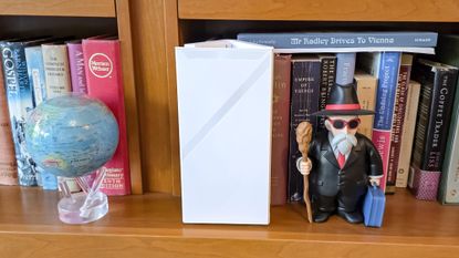 MSI Roamii BE Pro router on a bookshelf