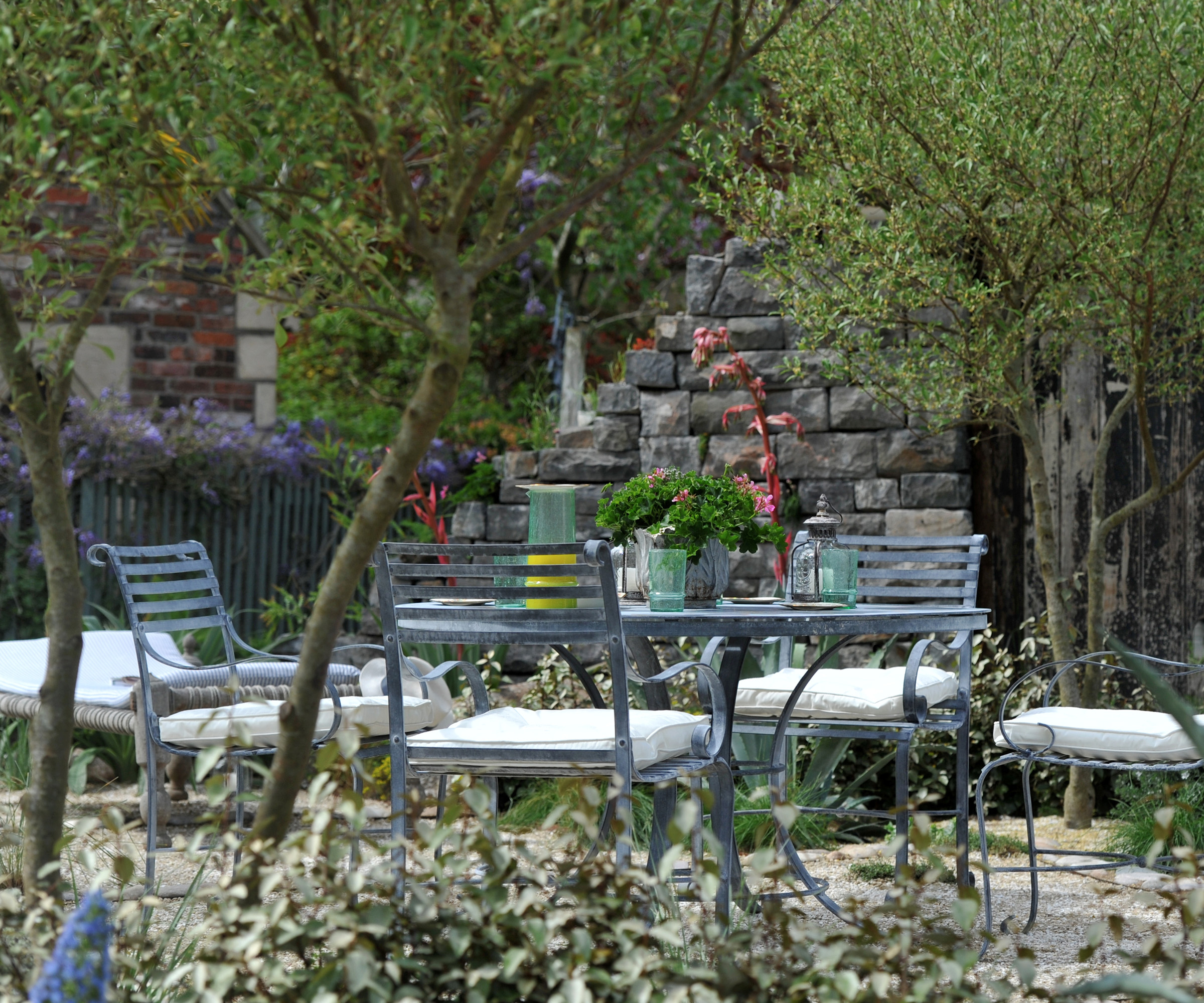 An outdoor seating area in a Mediterranean style garden