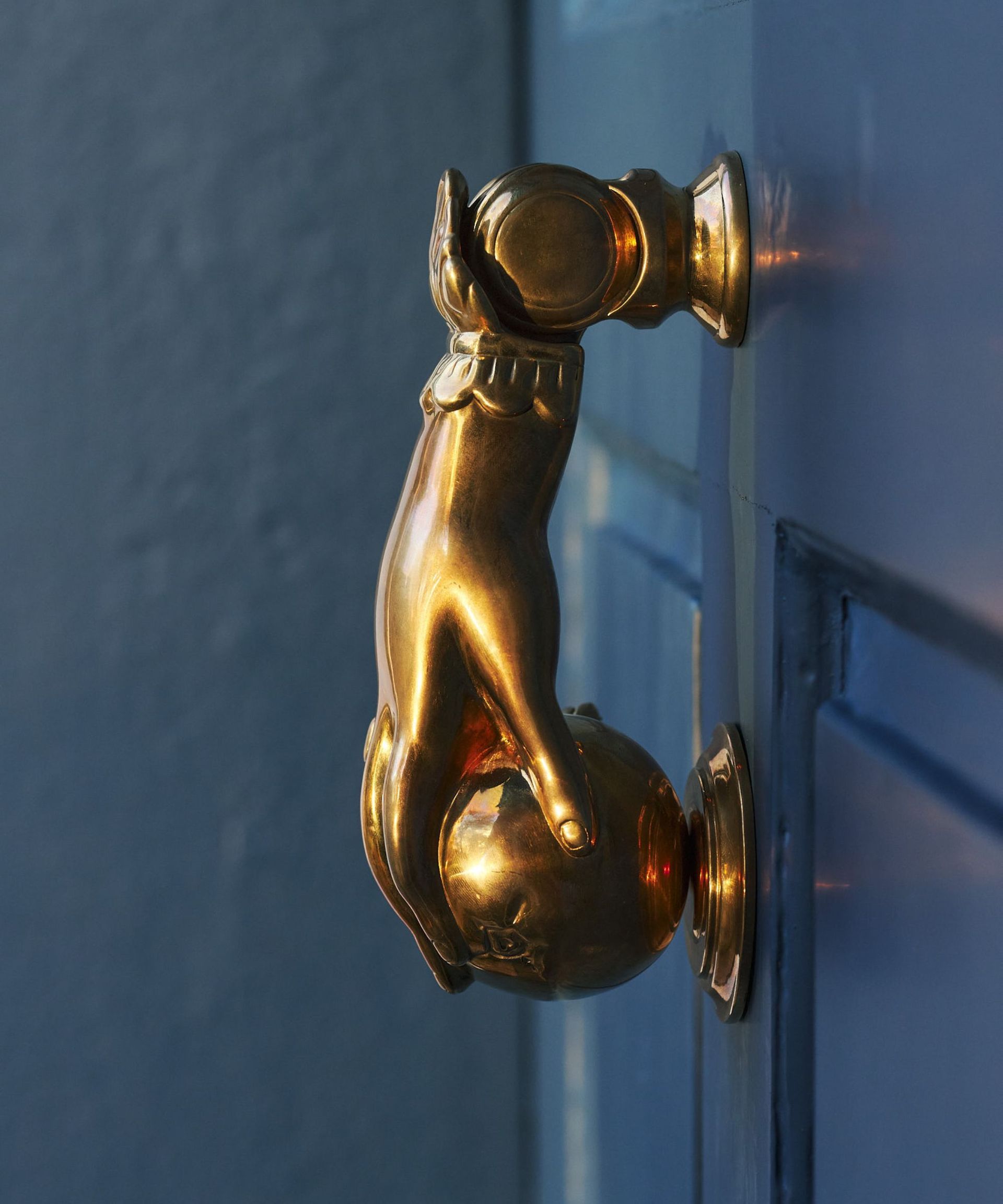 A doorknocker shaped like a hand