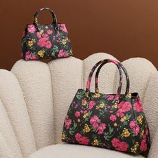 A floral Fiorelli handbag and purse on a cream fabric chair