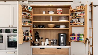 kitchen pantry with white cupboard with food items