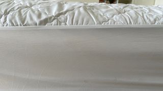 The side profile of the John Lewis Soft Touch Washable Quilted Mattress Protector