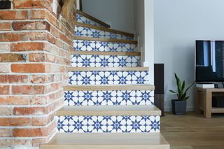 Blue star stair risers covered using peel and stick wallpaper