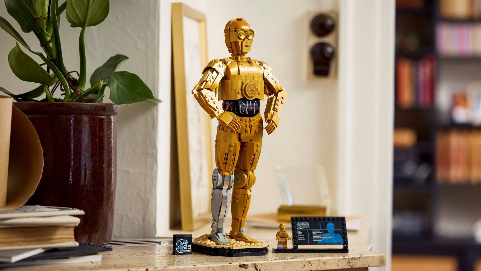 A Lego C-3PO build a droid, built, on a table.