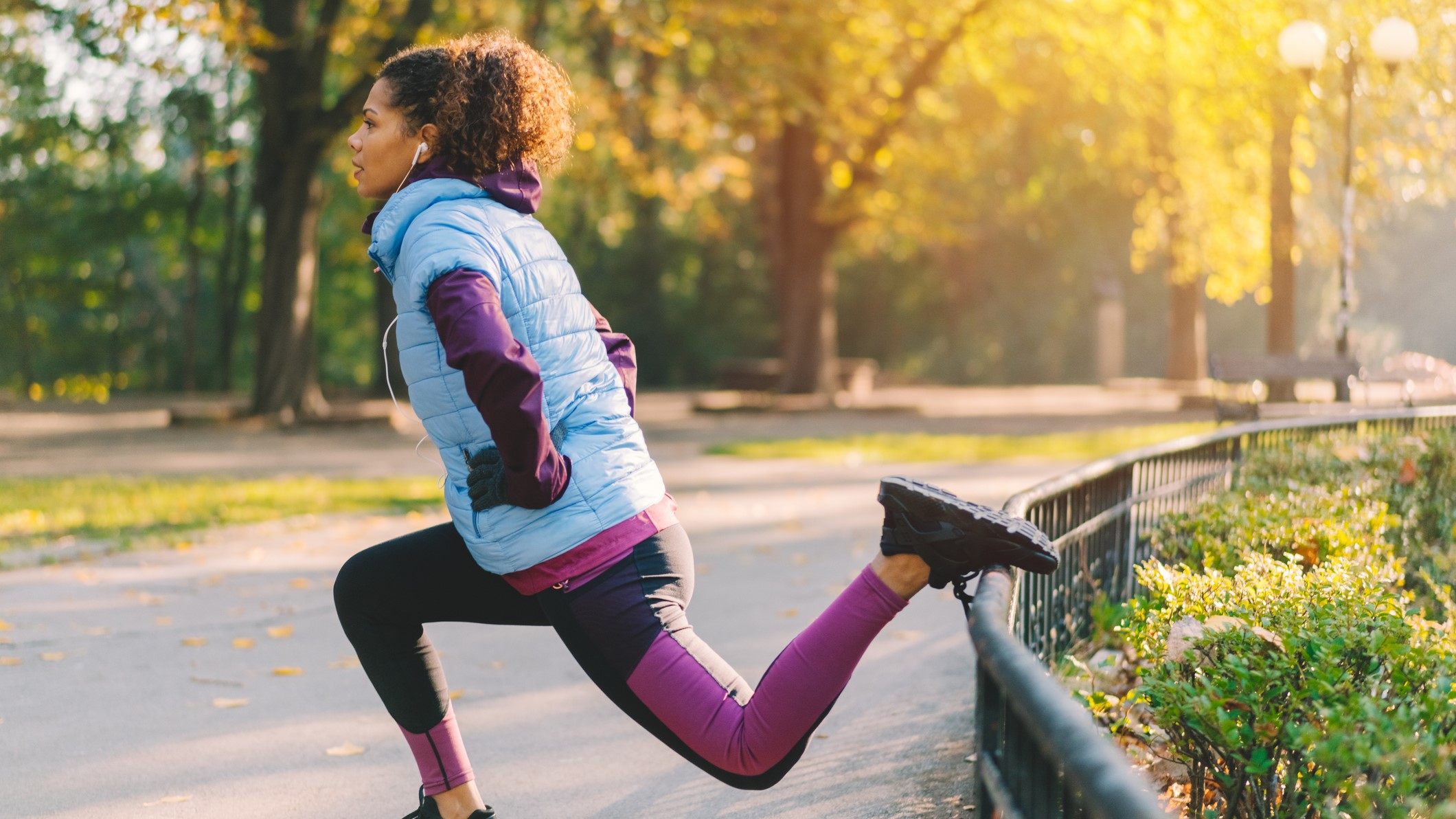 a photo of a woman doing a Bulgarian split squat in a park