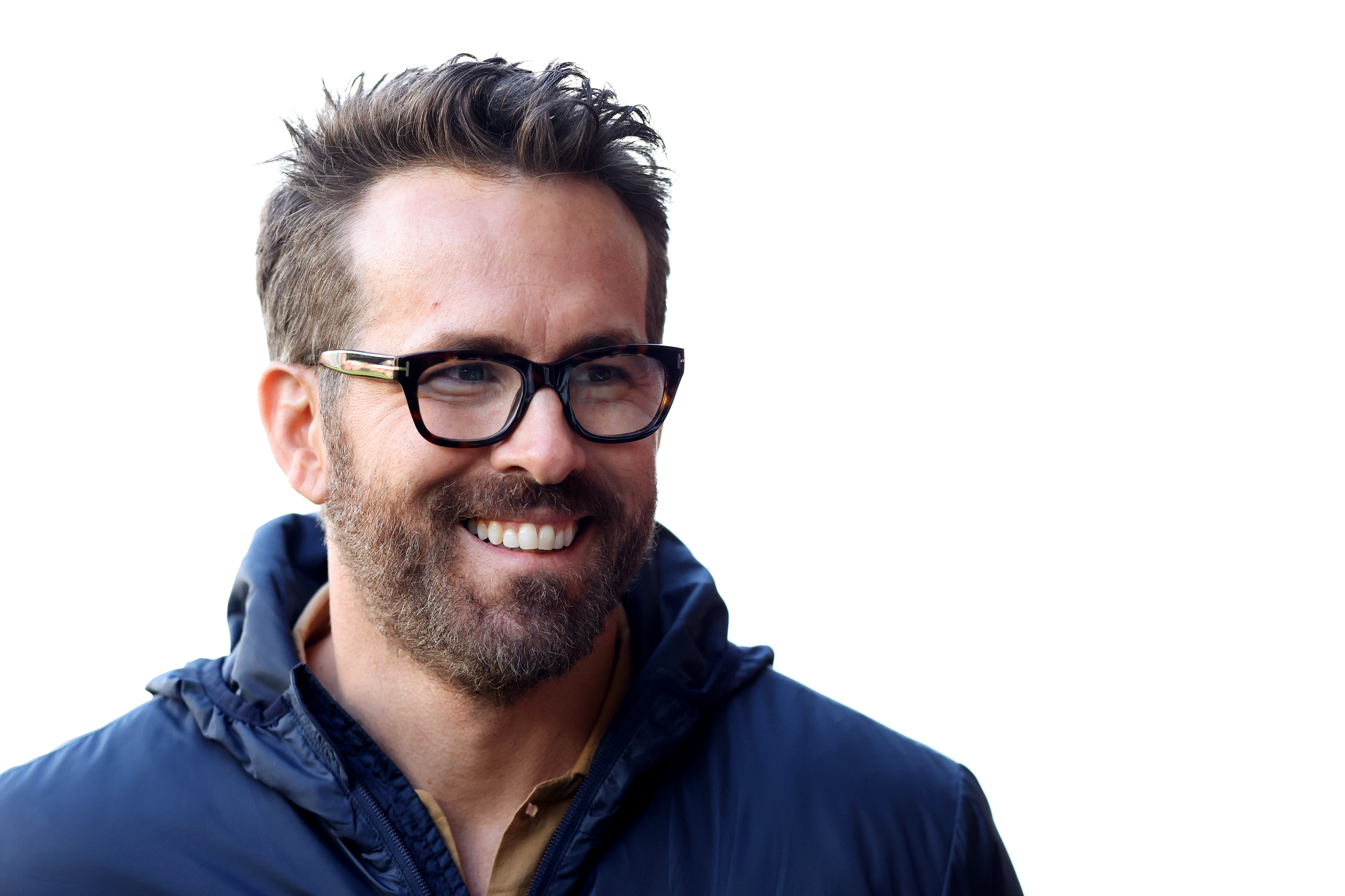 Ryan Reynolds, Owner of Wrexham smiles prior to the Vanarama National League match between Wrexham and Notts County at The Racecourse on April 10, 2023 in Wrexham, Wales.