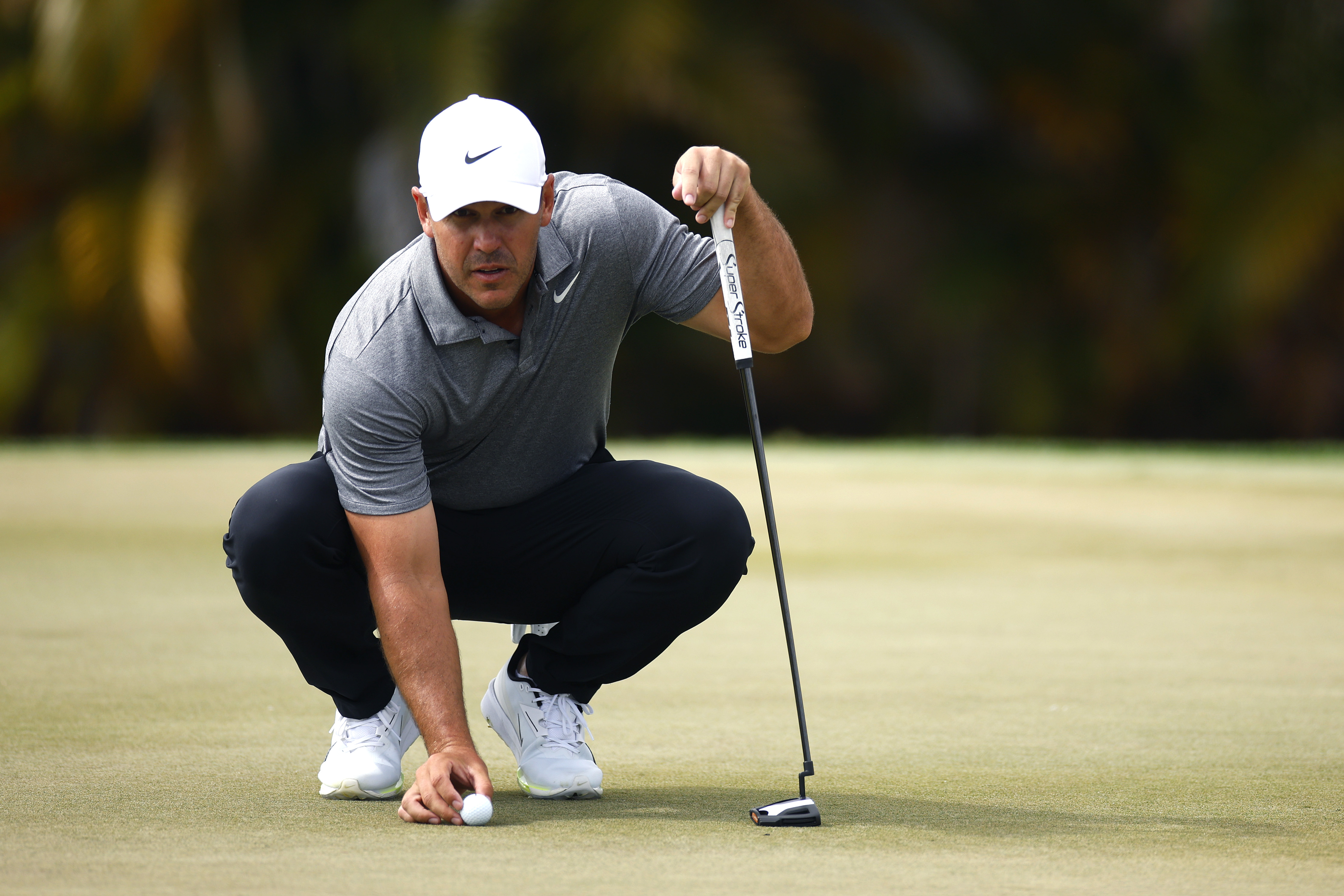 Brooks Koepka lines up a putt