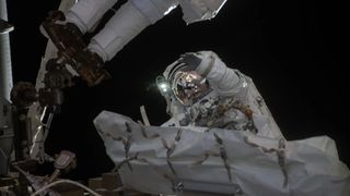 NASA astronaut Jessica Meir waves at the camera during a seven-hour, two-minute spacewalk outside the International Space Station on March 18, 2026.