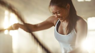 Woman doing battle rope waves