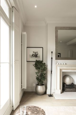 a fireplace alcove with a radiator