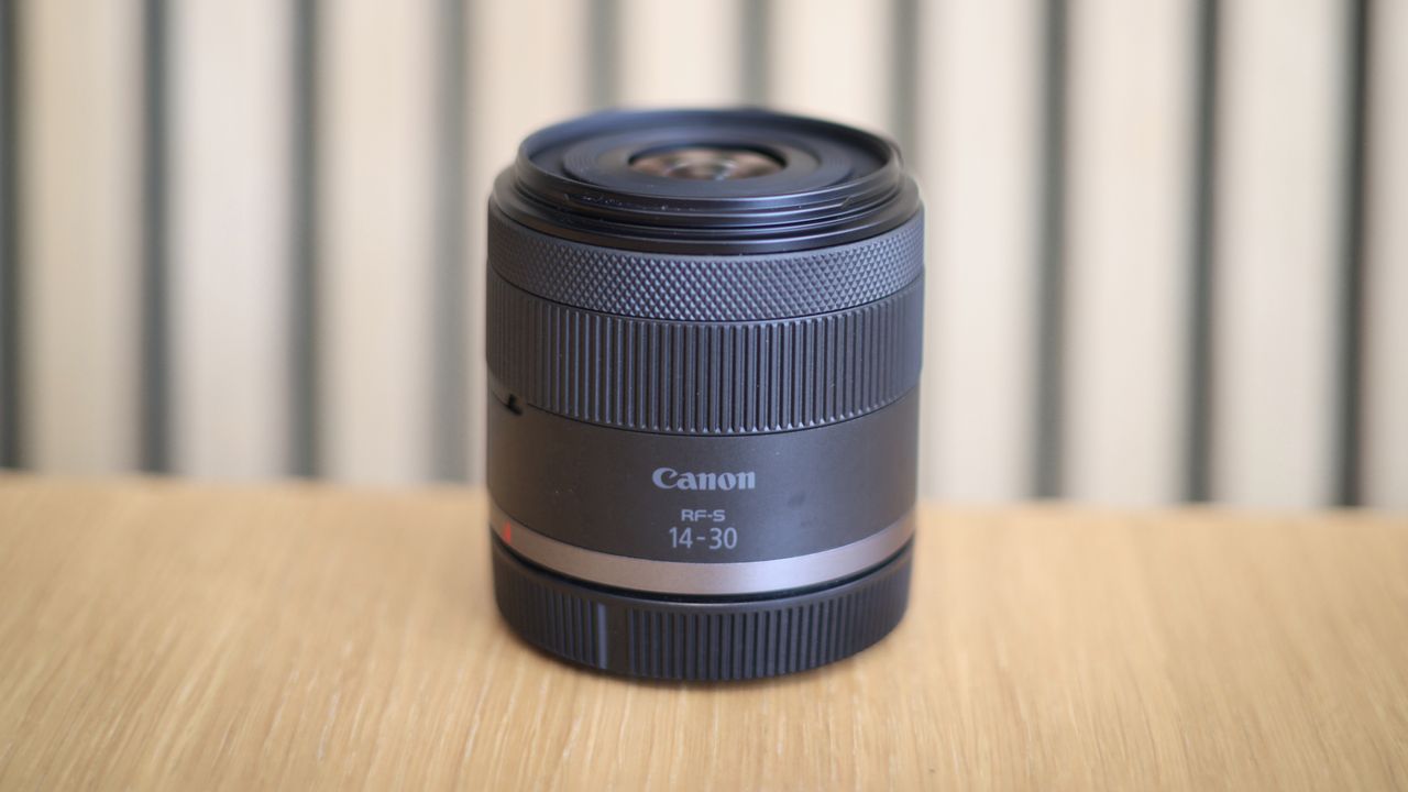 Canon RF 14-30mm f/4-6.3 STM PZ lens on a wooden surface