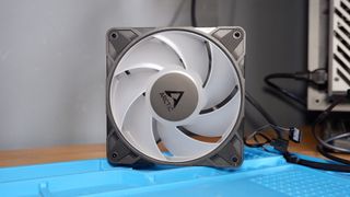 An Arctic P12 Pro fan on a soldering mat.
