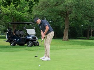 Jamie Donaldson hitting a putt after on the green