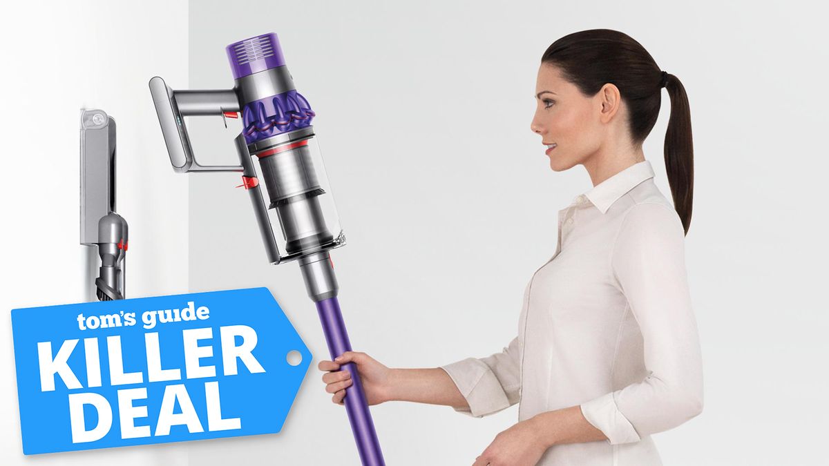 Promotional image featuring a woman returning the Dyson Cyclone V10 vacuum to its wall mount overlaid with a Tom&#039;s Guide &#039;Killer Deal&#039; badge