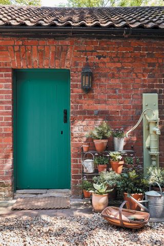 rustic garden wall and green painted gate