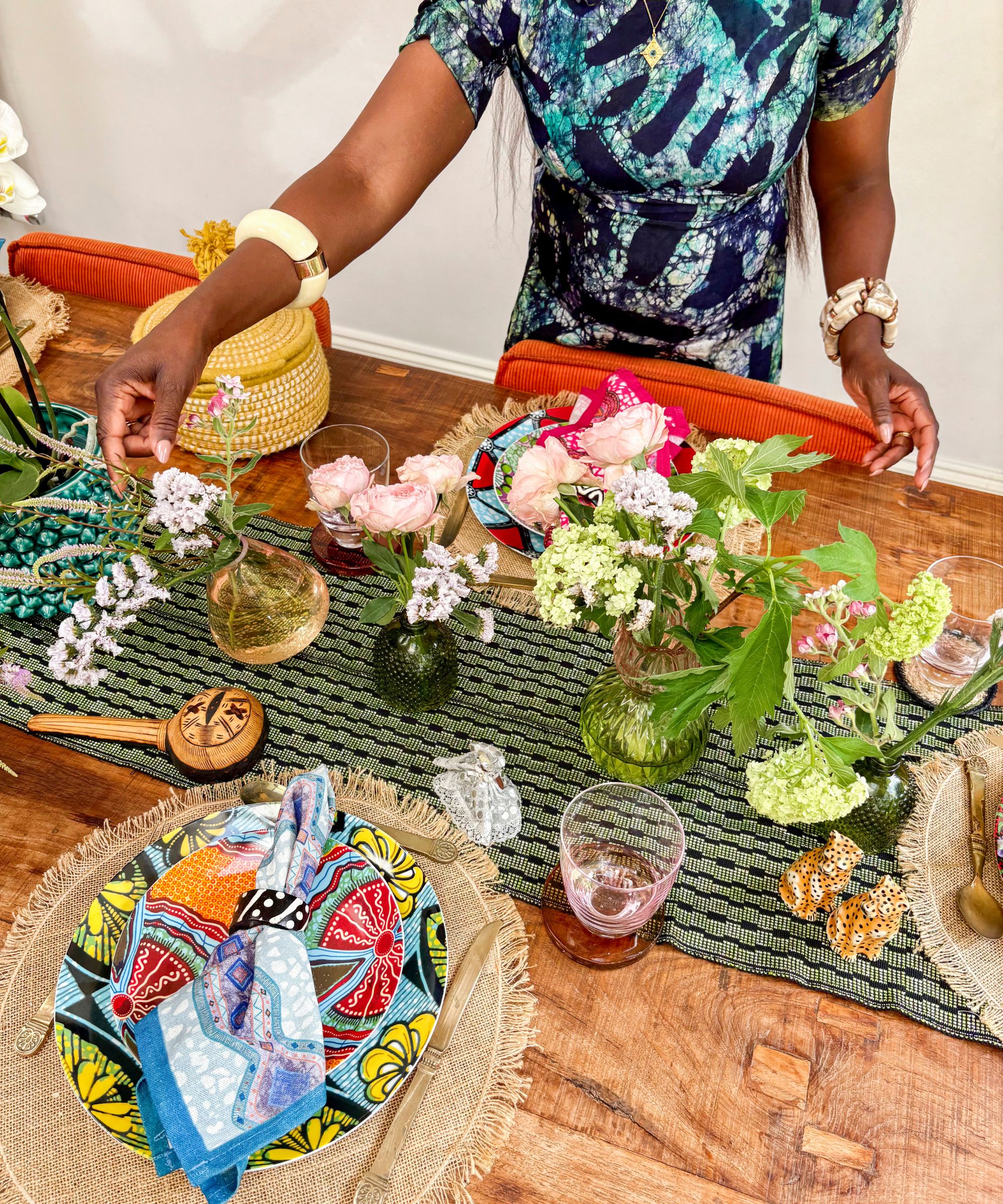 Eva Sonaike decorating a colorful West African-inspired table