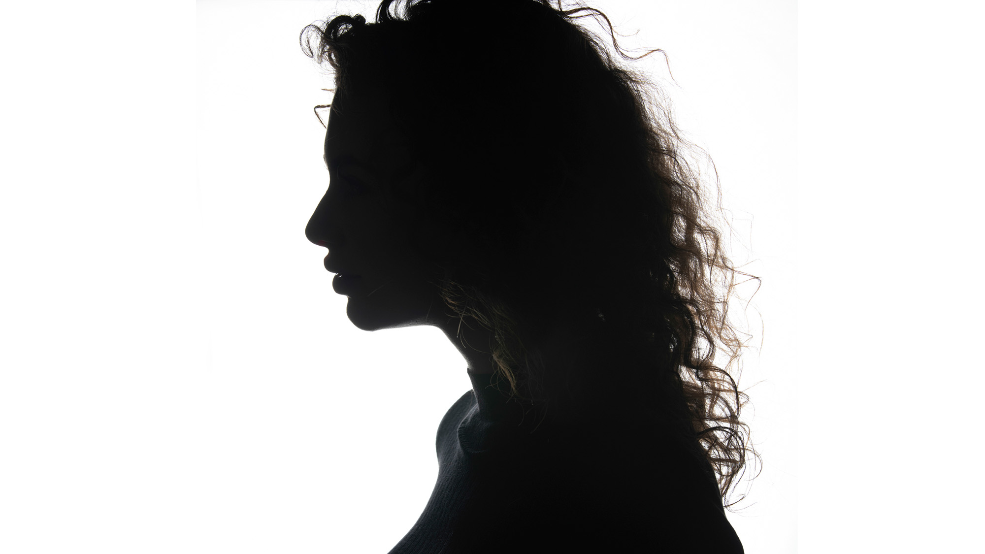 Close-up silhouette profile portrait of model by James Paterson on a white background