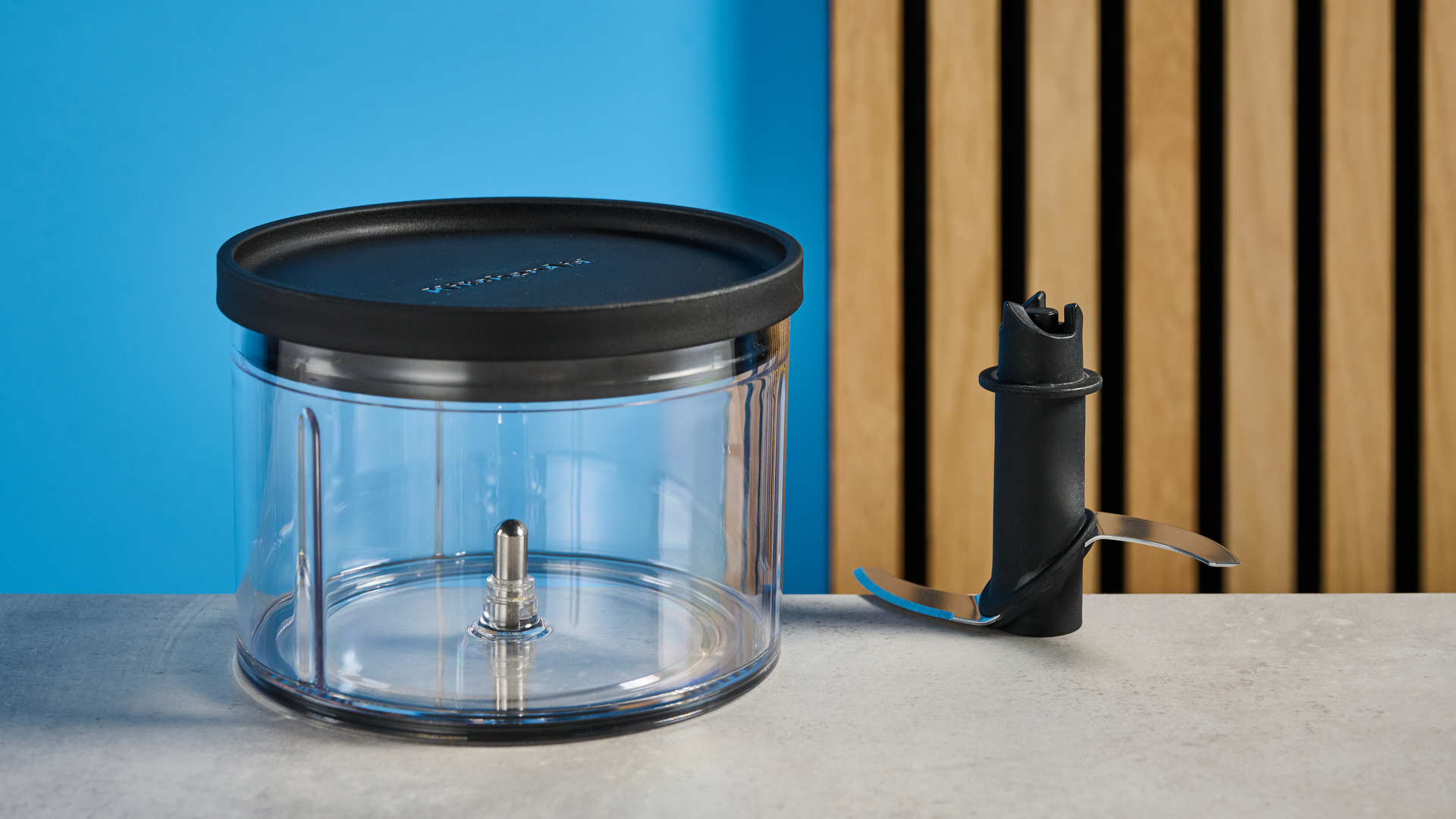 KitchenAid Cordless Top Down Food Chopper photographed in front of a blue background.