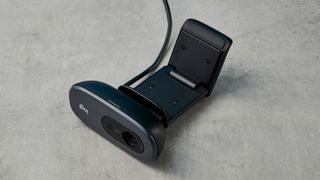 a small, black, oblong-shaped webcam with a universal attachment clip and a logi logo