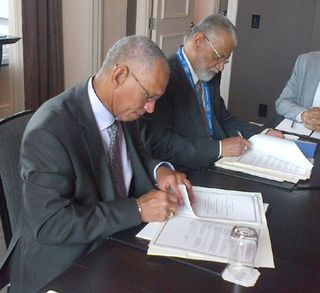 NASA Administrator Charles Bolden (left) and Chairman K. Radhakrishnan of the Indian Space Research Organisation sign documents on Sept. 30, 2014 to launch a joint Earth-observing satellite mission and establish a pathway for future joint missions to explore Mars.