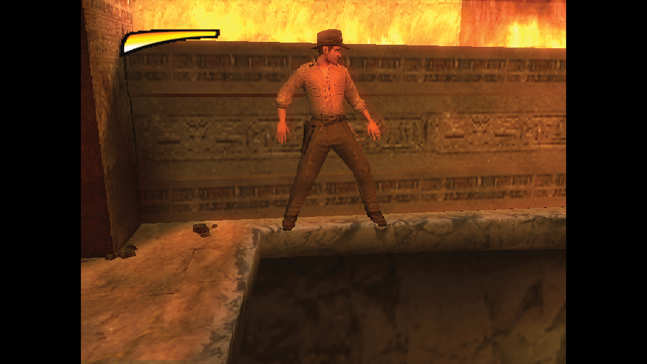Indy sidles by flames in Indiana Jones and the Staff of Kings for PS2 - from Retro Gamer magazine