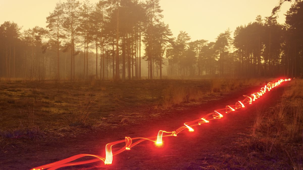 Stylised image of full-fibre cables running through the UK countryside