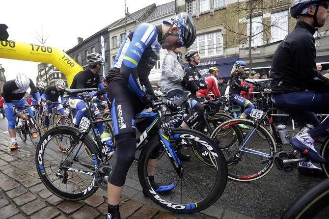 A rider makes a final adjustment before the start