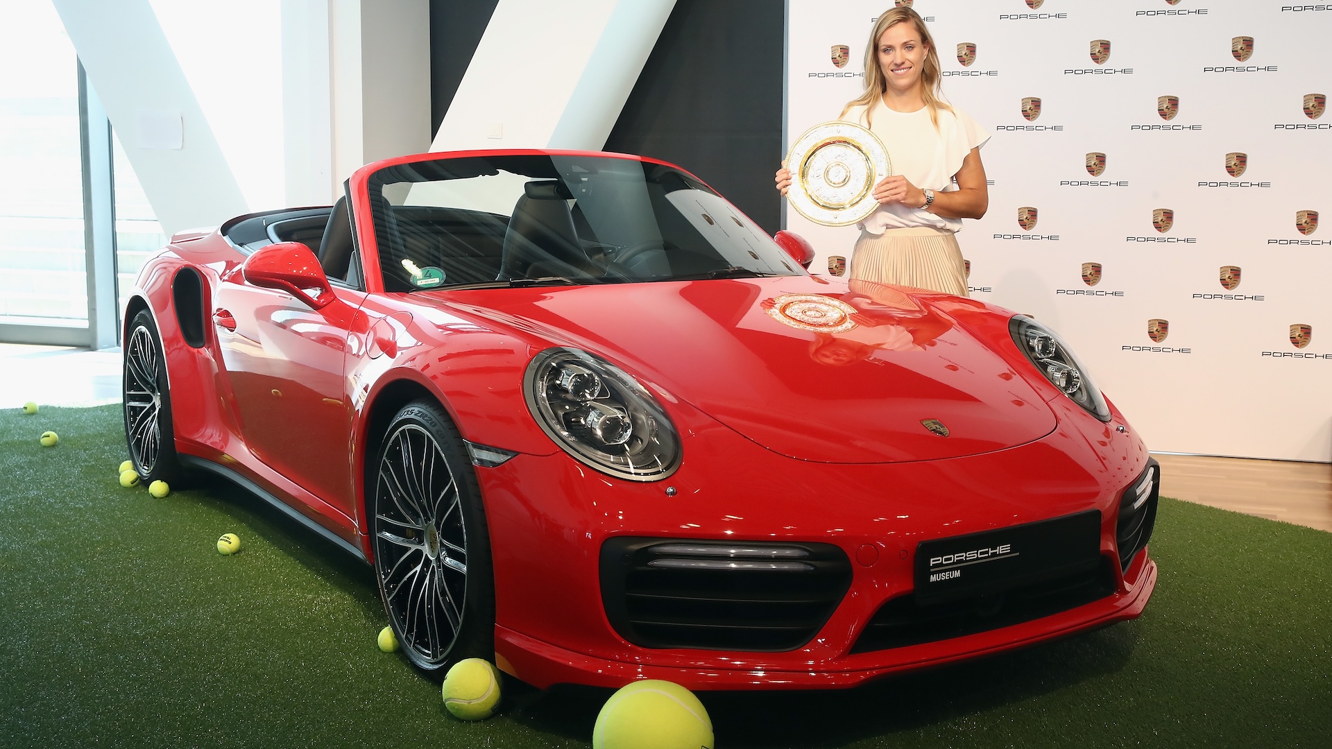 Porsche Brand Ambassador Angelique Kerber poses with the Wimbledon winnerÂ´s trophy and a Porsche 911 Turbo Cabriolet at the Porsche Museum on July 17, 2018 in Stuttgart, Germany.