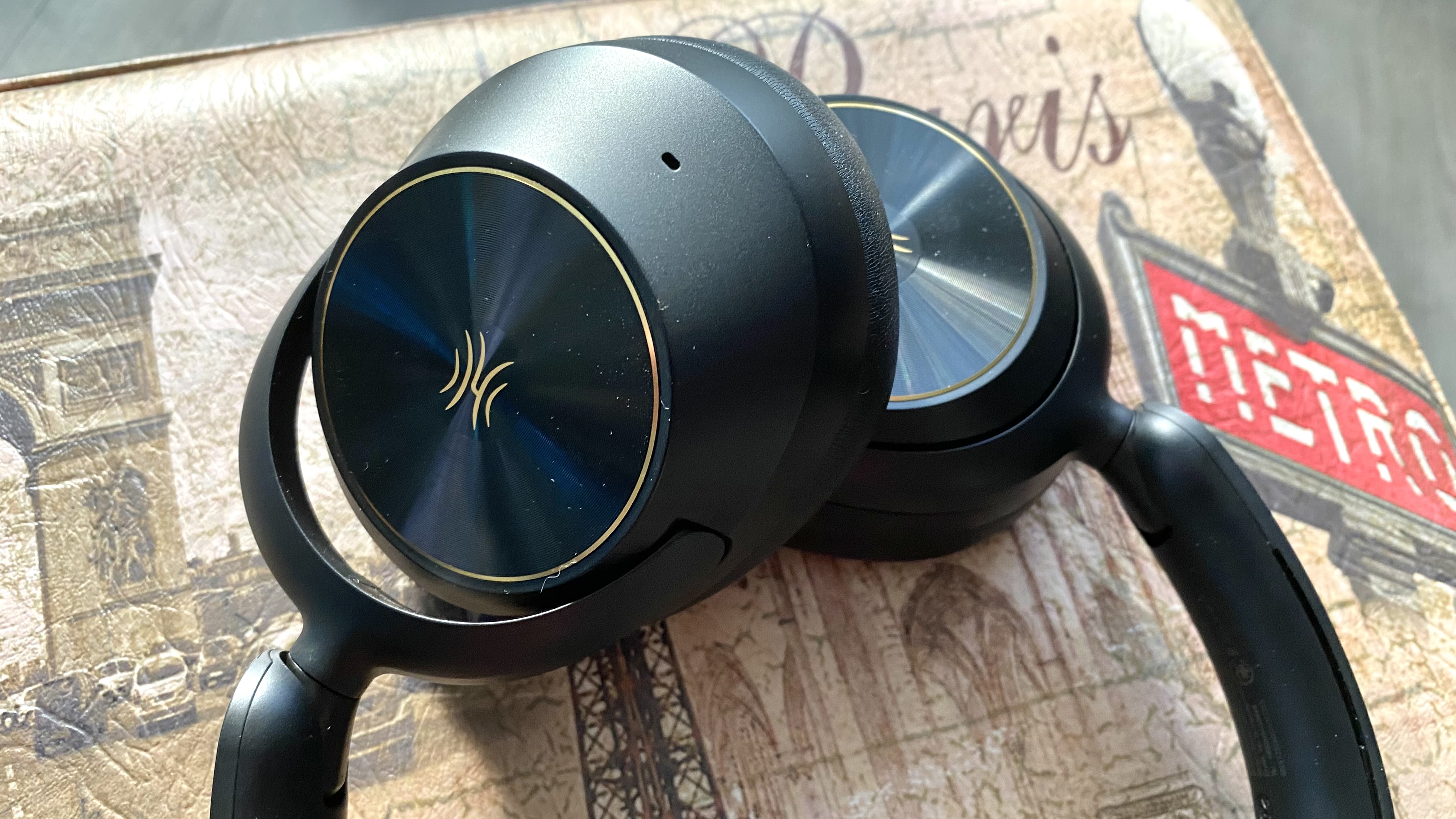 Earcups of the OneOdio Focus A6 over-ear headphones on a Parisian stool