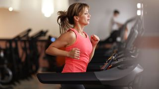 Woman running on a treadmill at a fitness center