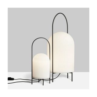 2 white floor lamps, in oval shapes, one taller, with black handles