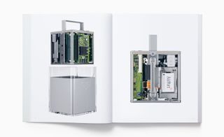 View of two pages inside the 'Designed by Apple in California' book featuring photos of the Power Mac G4 Cube from 2000